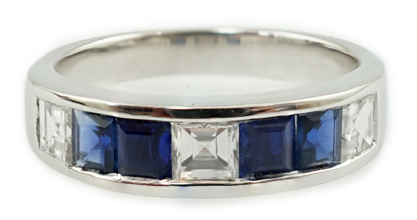 A modern 14k white gold, three stone diamond and four stone sapphire half hoop ring